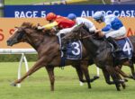 Three racehorses and jockeys sprinting toward the finish line on a grassy track, led by horse #3 with a red-and-yellow silks rider, closely followed by #4 in blue and white, with a cheering arena backdrop.