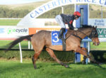 Horse and jockey racing atCasterton Race Club, saddlecloth number 3 visible, horse mid-stride on track against green grass and banners.